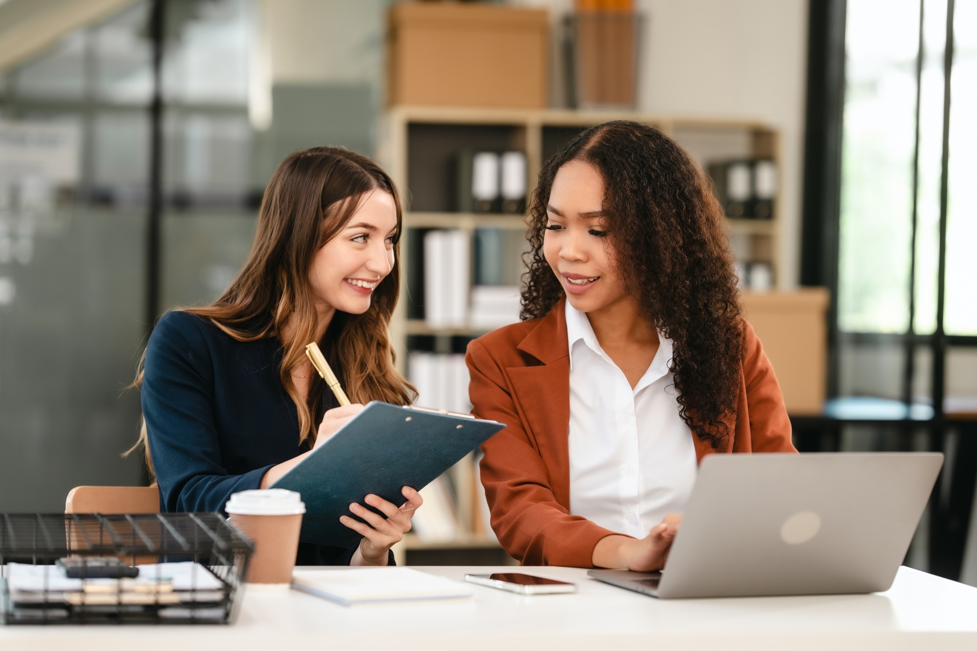 Two Professional Caucasian With African American Businesswoman Friends Collaboration, Working Together at Office, Using Laptop, Generally Accepted Audit Standards, Earnings Before Interest and Taxes.